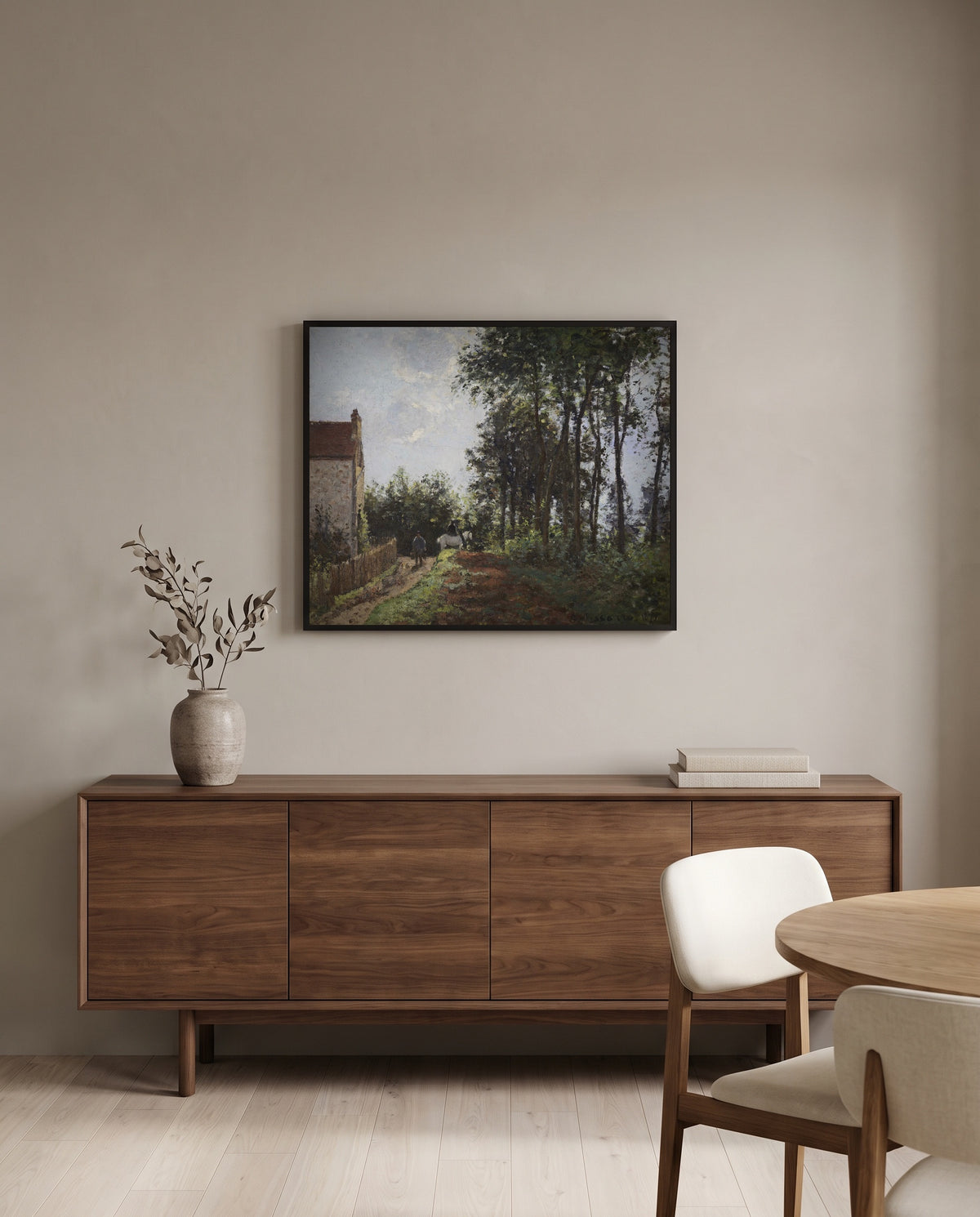 The Road Near the Farm by Camille Pissarro in a black frame above a walnut sideboard in a dining room