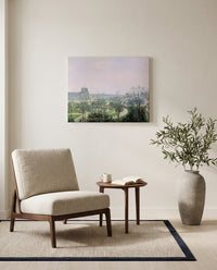 Tuileries Gardens by Camille Pissarro as a stretched canvas above a linen lounge chair in a reading corner