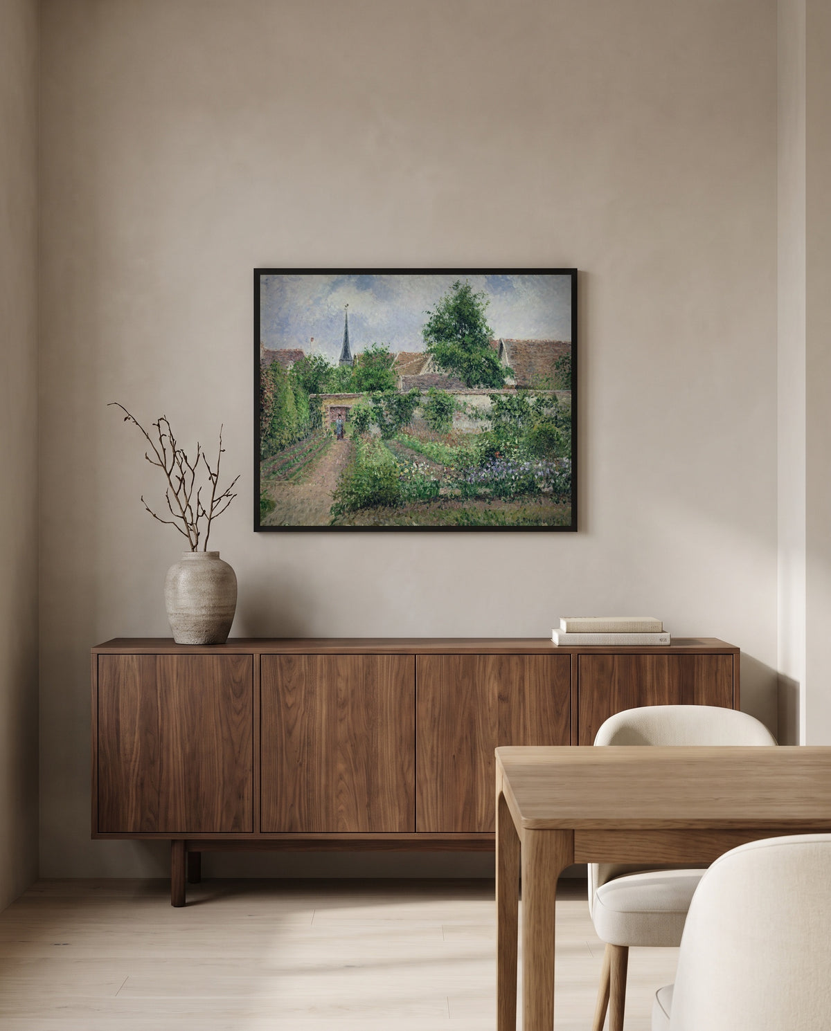 Vegetable Garden, Éragny by Camille Pissarro in a black frame above a walnut sideboard in a dining room