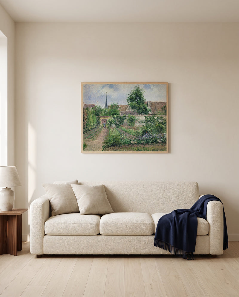 Vegetable Garden, Éragny by Camille Pissarro framed in natural oak above a cream sofa in a warm living room