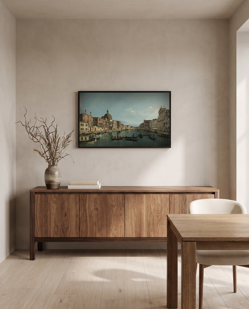 Grand Canal, S. Simeone by Canaletto in a black frame above a walnut sideboard in a dining room
