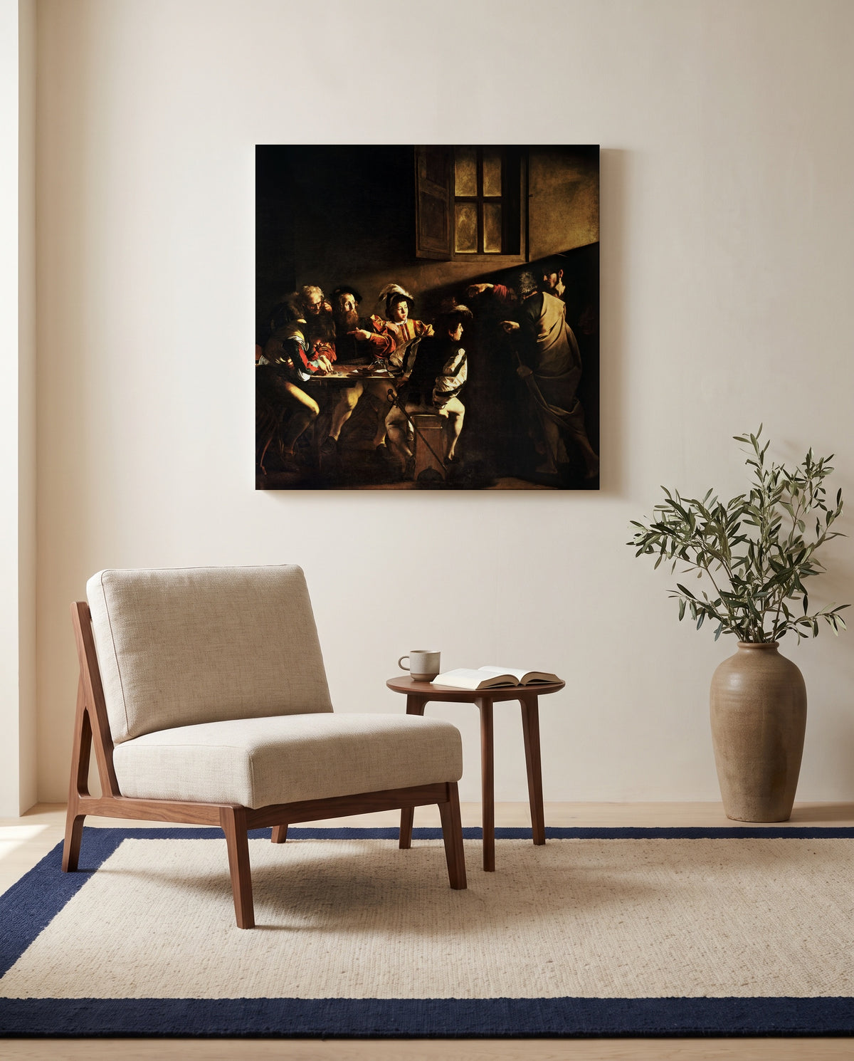 The Calling of Saint Matthew by Caravaggio as a stretched canvas above a linen lounge chair in a reading corner