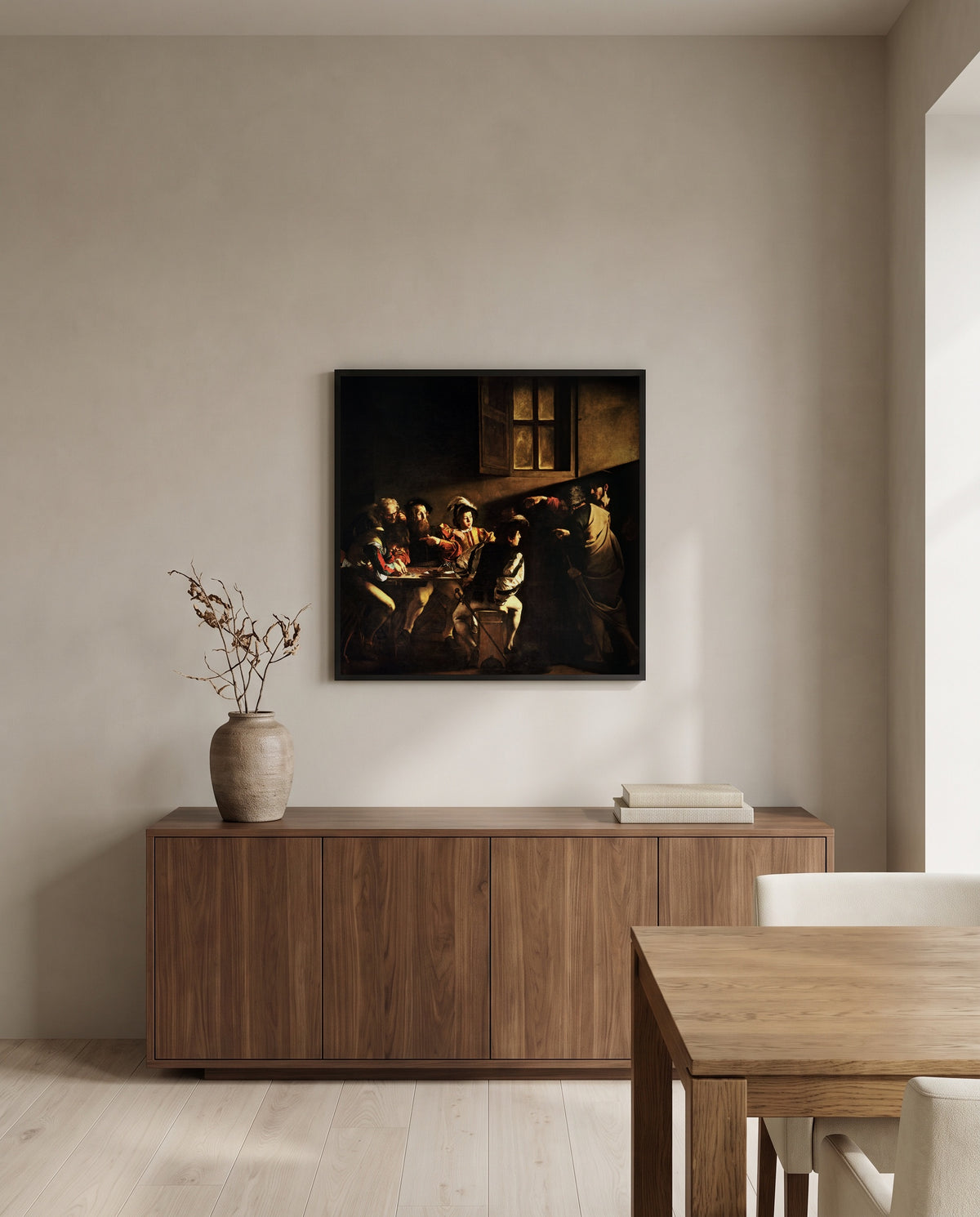 The Calling of Saint Matthew by Caravaggio in a black frame above a walnut sideboard in a dining room