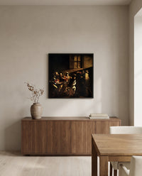 The Calling of Saint Matthew by Caravaggio in a black frame above a walnut sideboard in a dining room