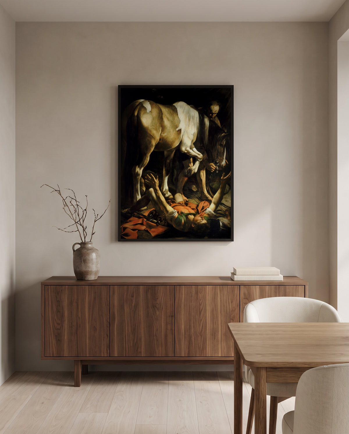 The Conversion of Saul by Caravaggio in a black frame above a walnut sideboard in a dining room