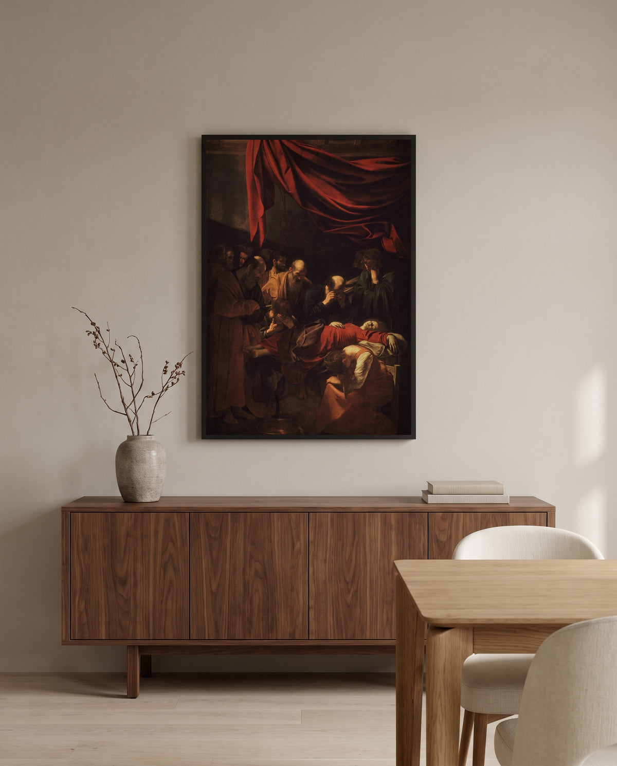 Death of the Virgin by Caravaggio in a black frame above a walnut sideboard in a dining room