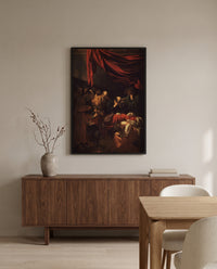 Death of the Virgin by Caravaggio in a black frame above a walnut sideboard in a dining room