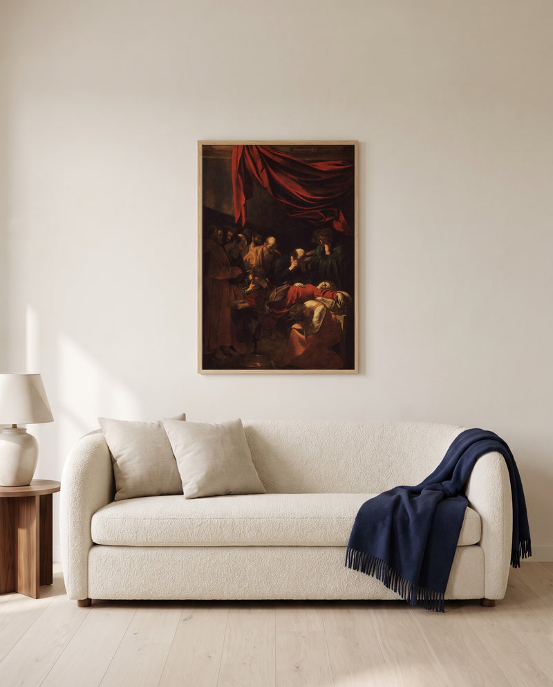 Death of the Virgin by Caravaggio framed in natural oak above a cream sofa in a warm living room