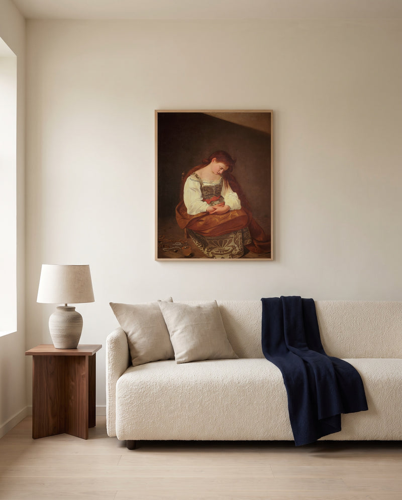 Penitent Magdalene by Caravaggio framed in natural oak above a cream sofa in a warm living room