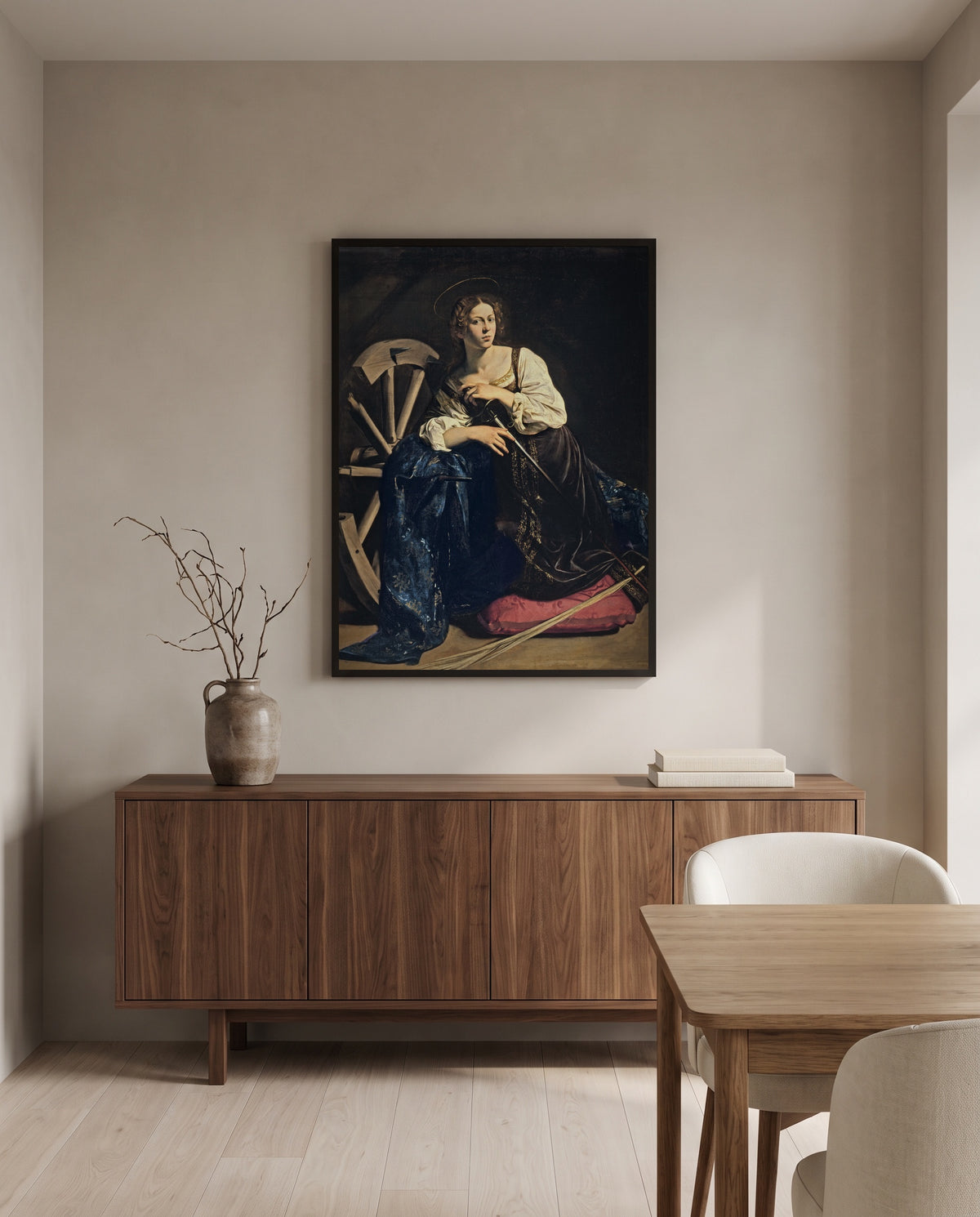 Saint Catherine by Caravaggio in a black frame above a walnut sideboard in a dining room