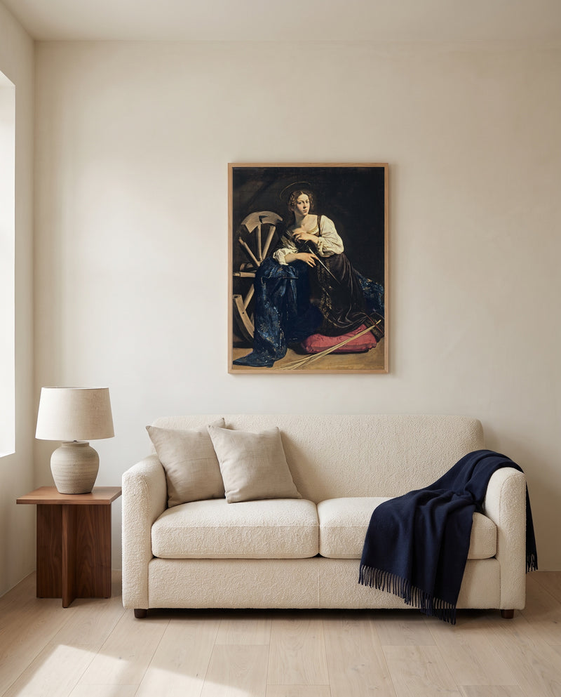 Saint Catherine by Caravaggio framed in natural oak above a cream sofa in a warm living room