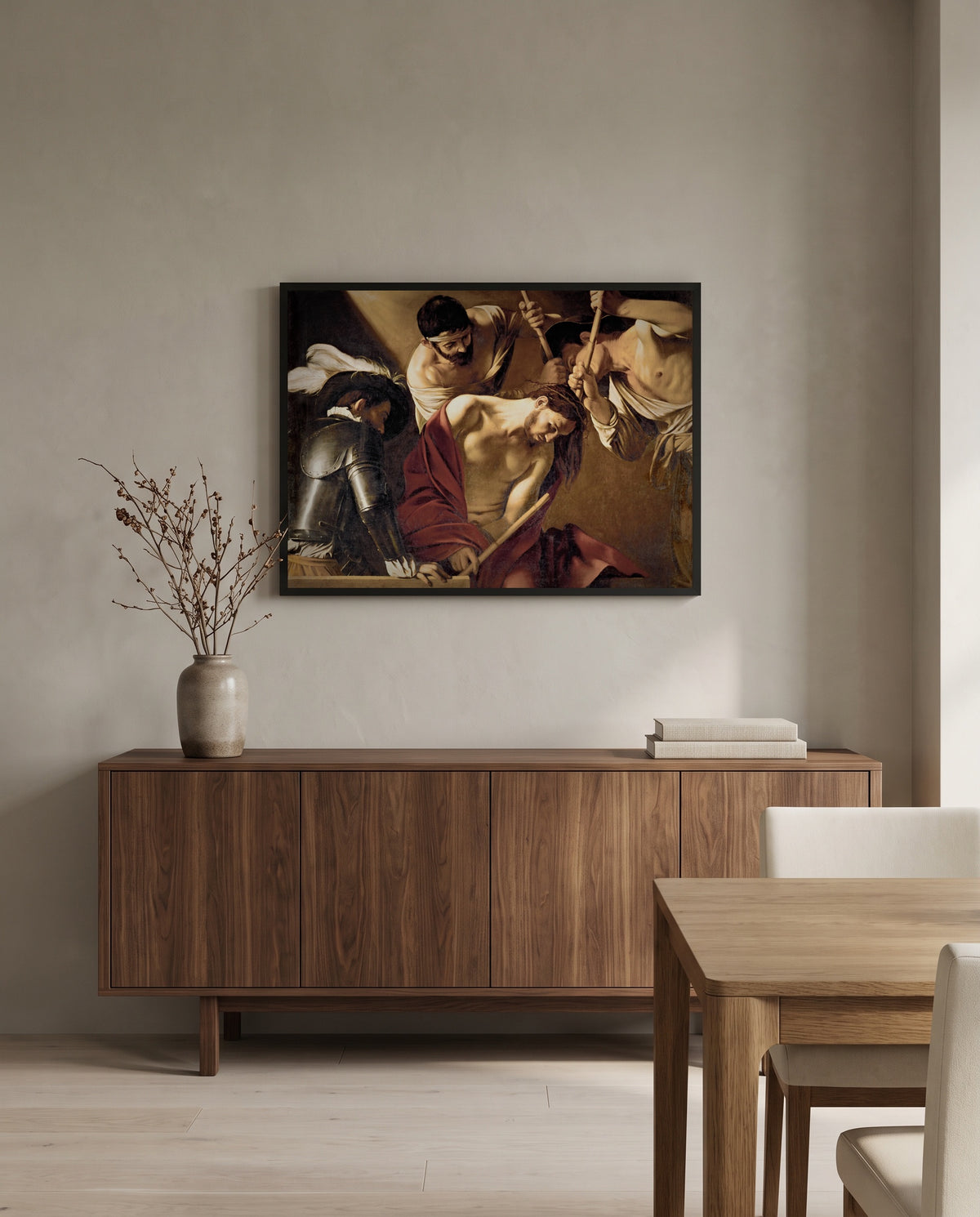 The Crowning with Thorns by Caravaggio in a black frame above a walnut sideboard in a dining room