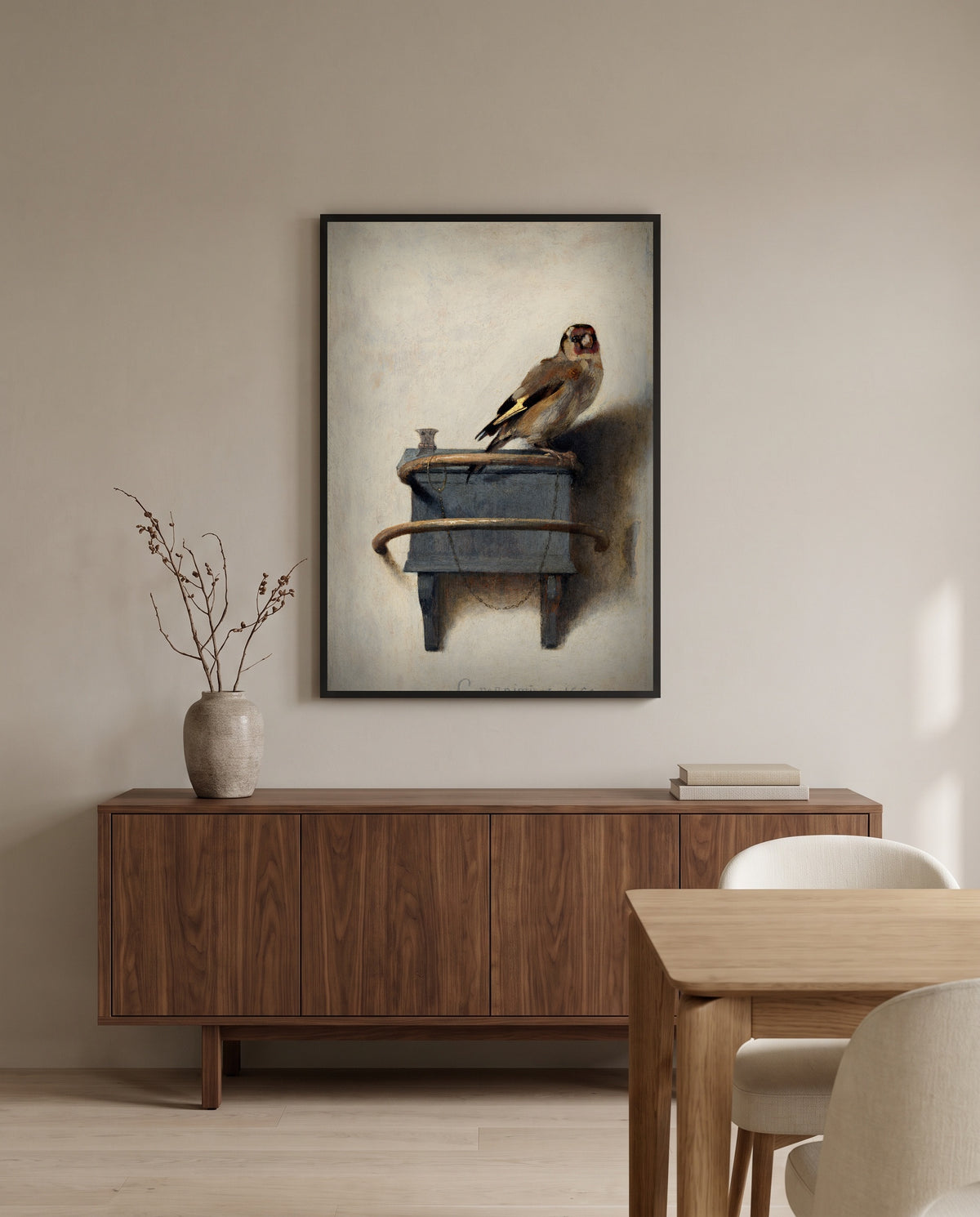 The Goldfinch by Carel Fabritius in a black frame above a walnut sideboard in a dining room