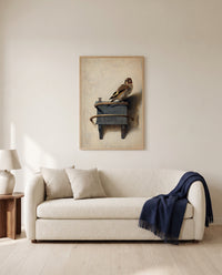 The Goldfinch by Carel Fabritius framed in natural oak above a cream sofa in a warm living room