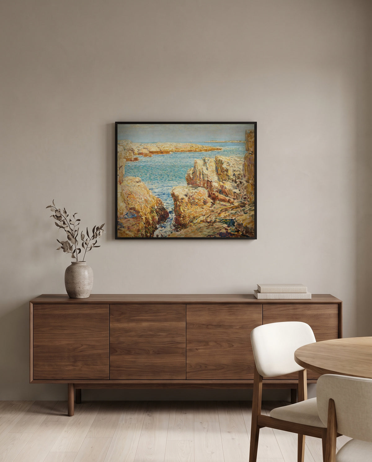 Coast Scene, Isles of Shoals by Childe Hassam in a black frame above a walnut sideboard in a dining room