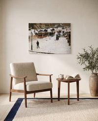Fifth Avenue in Winter by Childe Hassam as a stretched canvas above a linen lounge chair in a reading corner