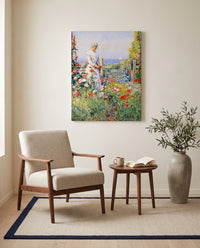 In the Garden by Childe Hassam as a stretched canvas above a linen lounge chair in a reading corner