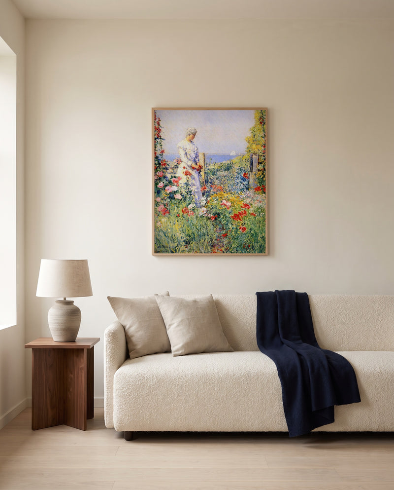 In the Garden by Childe Hassam framed in natural oak above a cream sofa in a warm living room