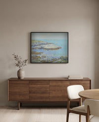 Isles of Shoals by Childe Hassam in a black frame above a walnut sideboard in a dining room