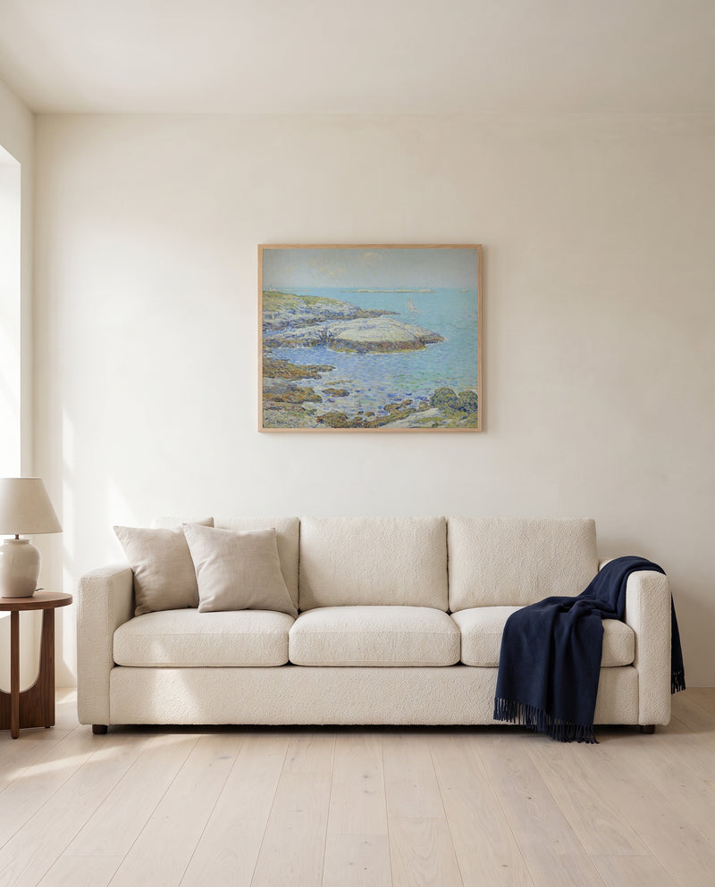 Isles of Shoals by Childe Hassam framed in natural oak above a cream sofa in a warm living room