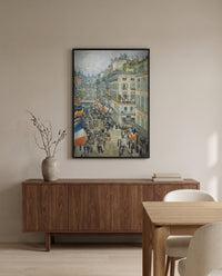 July Fourteenth, Rue Daunou by Childe Hassam in a black frame above a walnut sideboard in a dining room