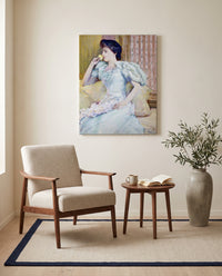 Lillie Langtry by Childe Hassam as a stretched canvas above a linen lounge chair in a reading corner