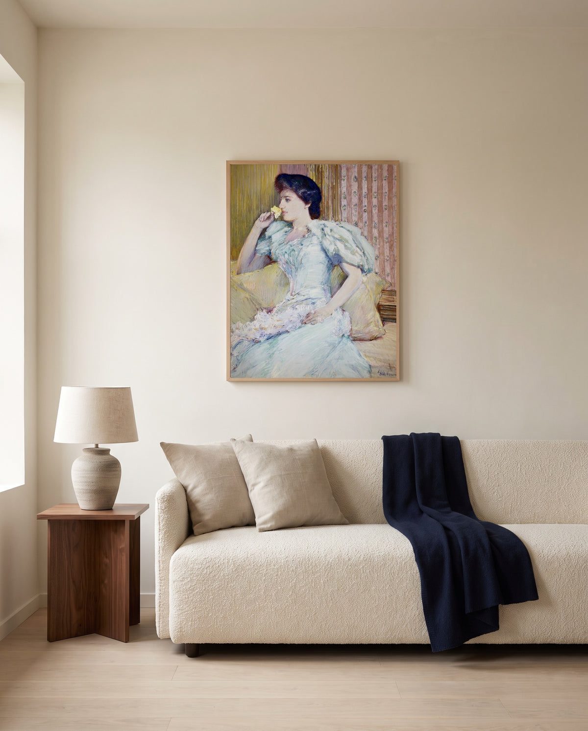 Lillie Langtry by Childe Hassam framed in natural oak above a cream sofa in a warm living room