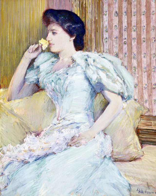 Lillie Langtry by Childe Hassam: a woman in a pale blue gown with white fur on a yellow sofa, holding a yellow rose
