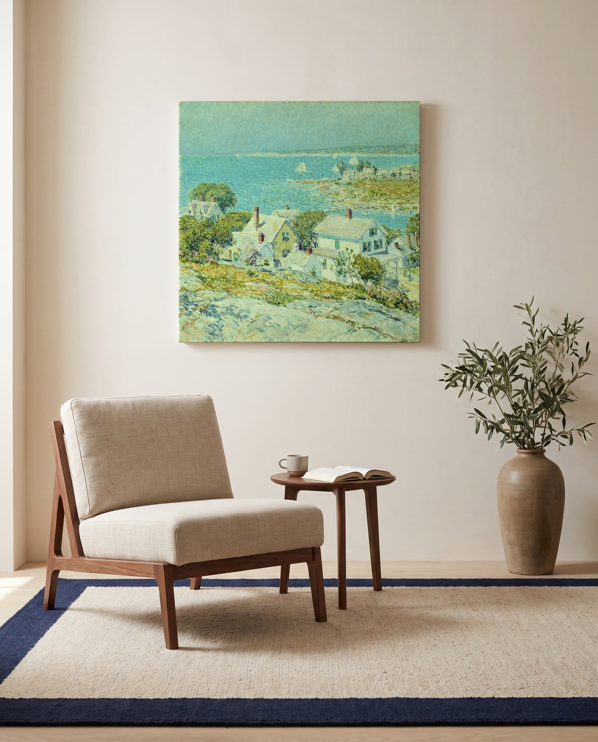 New England Headlands by Childe Hassam as a stretched canvas above a linen lounge chair in a reading corner