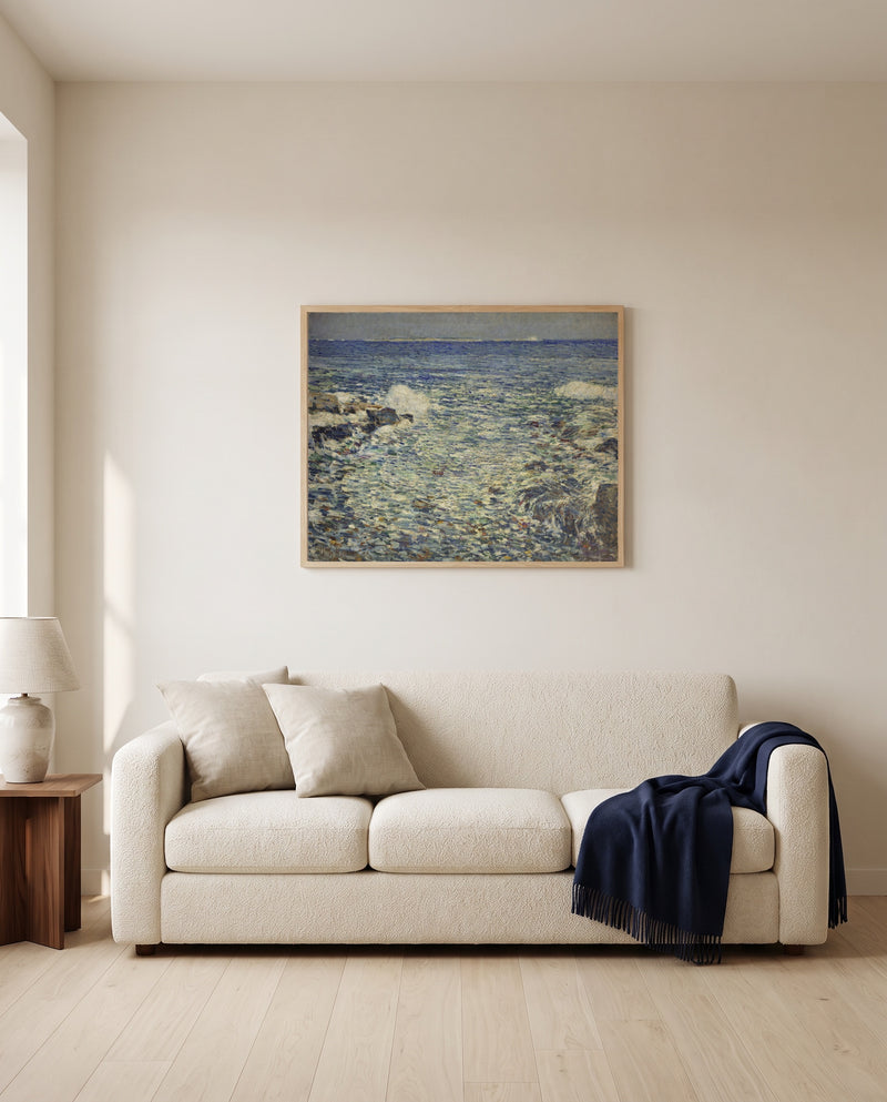 Surf, Isles of Shoals by Childe Hassam framed in natural oak above a cream sofa in a warm living room