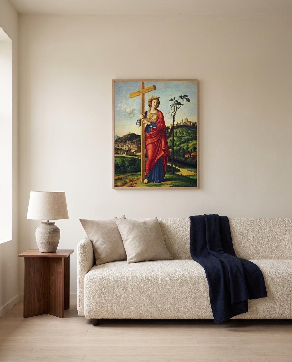 Saint Helena by Cima da Conegliano framed in natural oak above a cream sofa in a warm living room