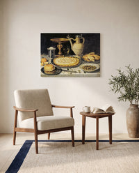 Tazza, Jug and Pie by Clara Peeters as a stretched canvas above a linen lounge chair in a reading corner
