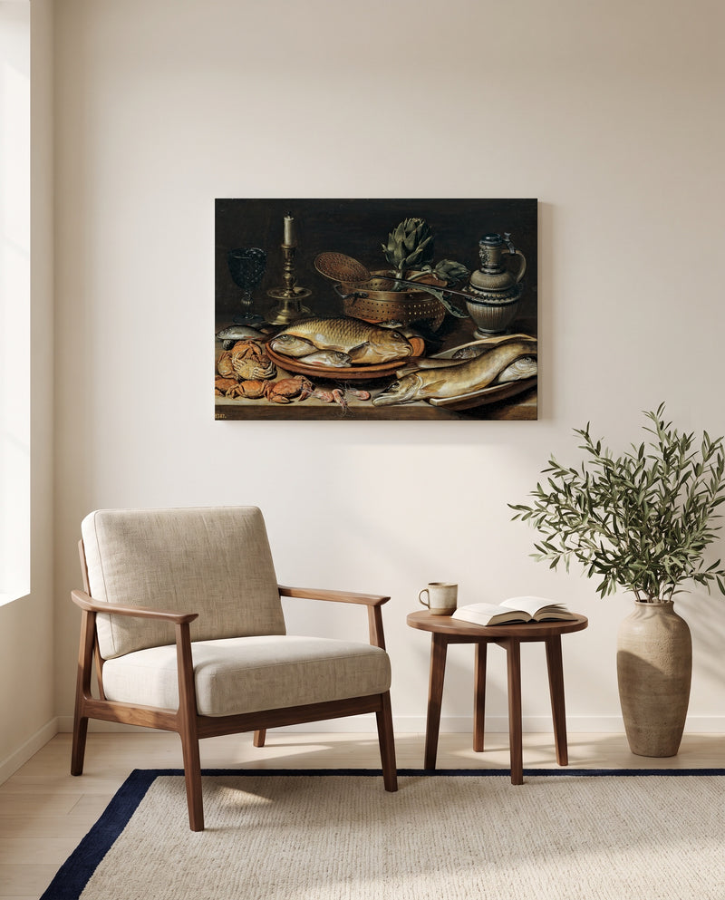 Fish and a Candlestick by Clara Peeters as a stretched canvas above a linen lounge chair in a reading corner