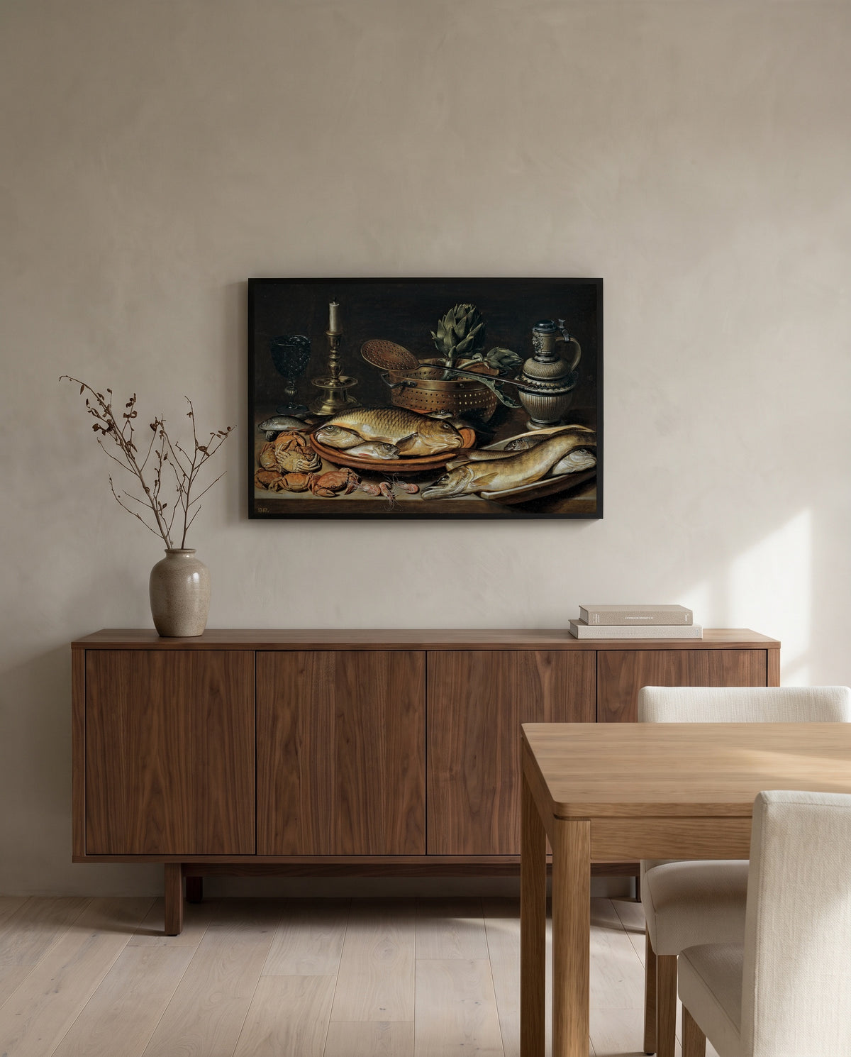 Fish and a Candlestick by Clara Peeters in a black frame above a walnut sideboard in a dining room