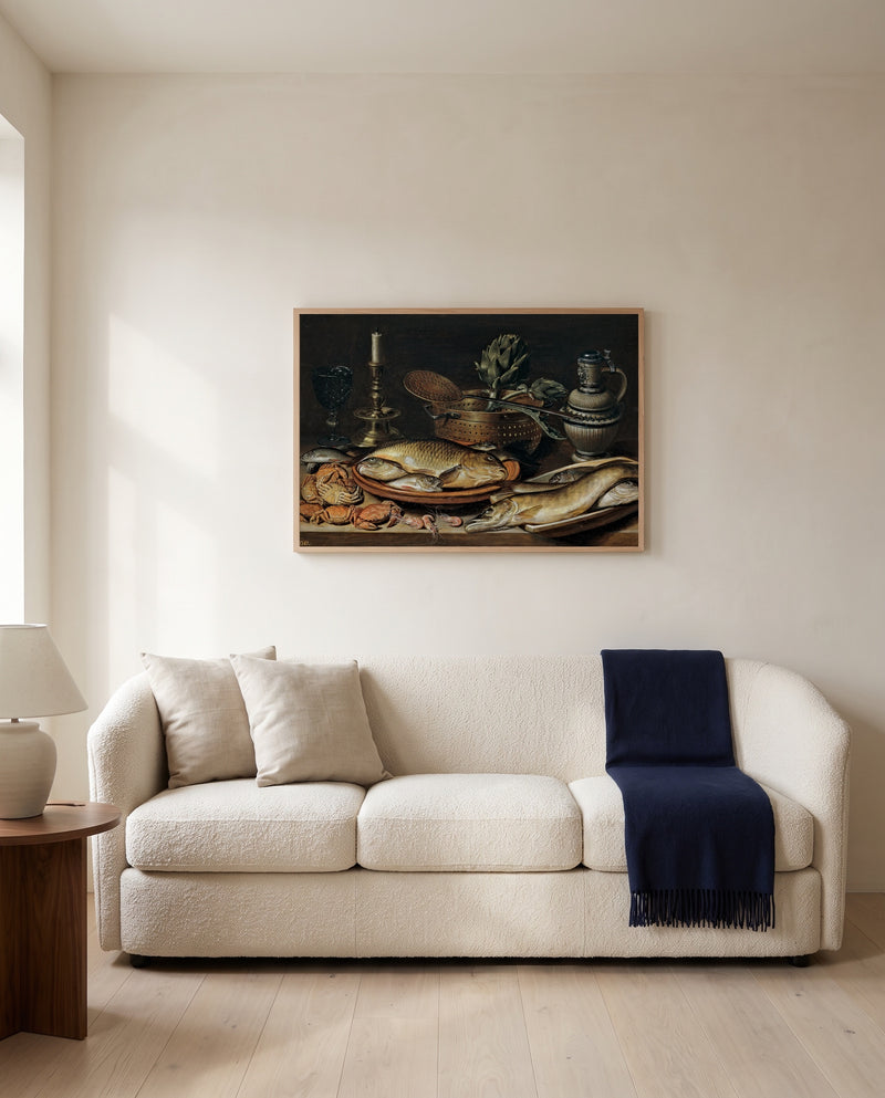 Fish and a Candlestick by Clara Peeters framed in natural oak above a cream sofa in a warm living room
