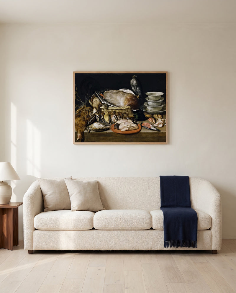 Game and Poultry by Clara Peeters framed in natural oak above a cream sofa in a warm living room