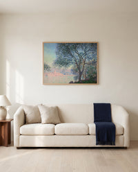 Antibes, Salis Gardens by Claude Monet framed in natural oak above a cream sofa in a warm living room