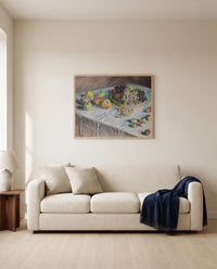 Apples and Grapes by Claude Monet framed in natural oak above a cream sofa in a warm living room