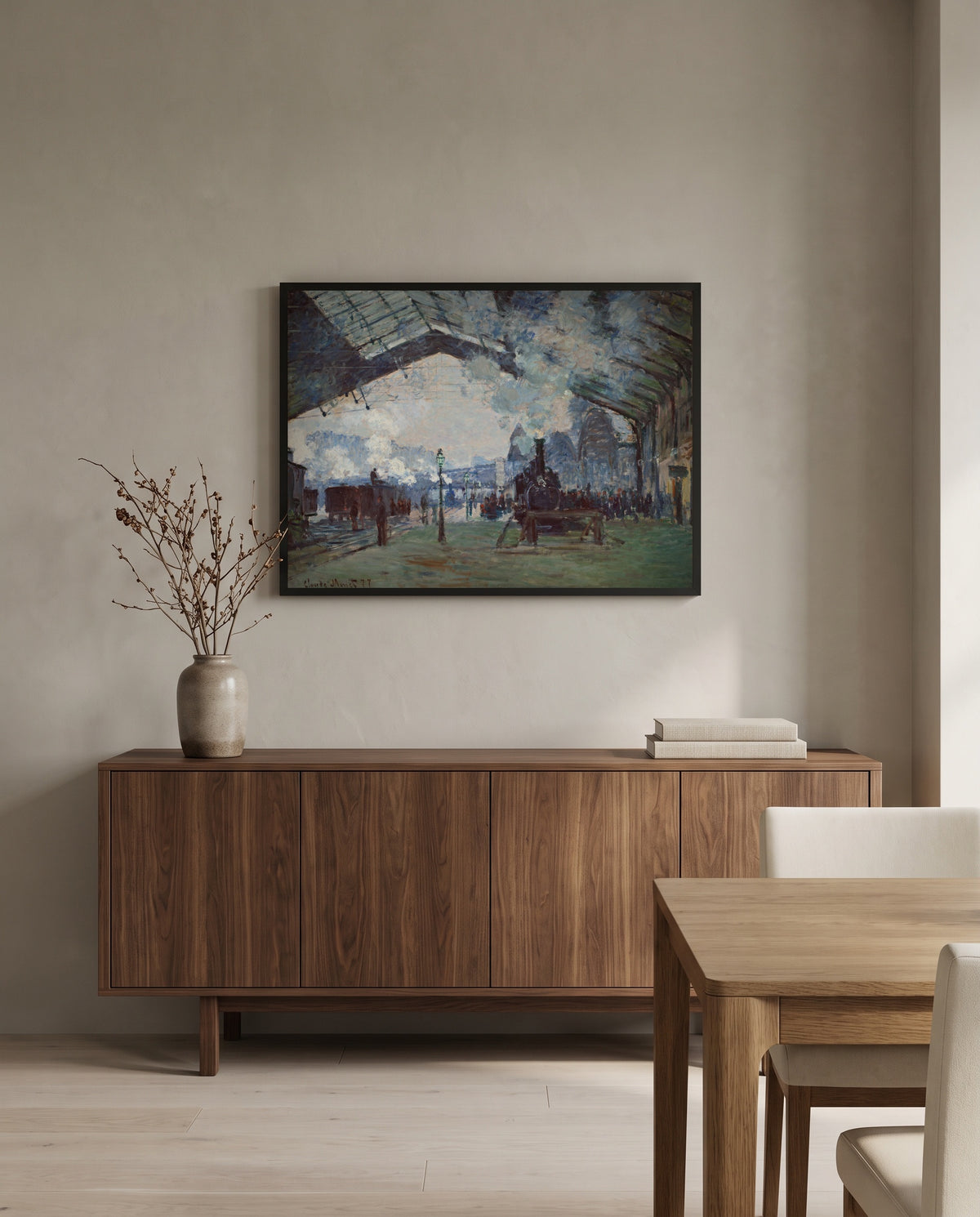 Arrival of the Normandy Train by Claude Monet in a black frame above a walnut sideboard in a dining room