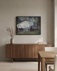 Arrival of the Normandy Train by Claude Monet in a black frame above a walnut sideboard in a dining room