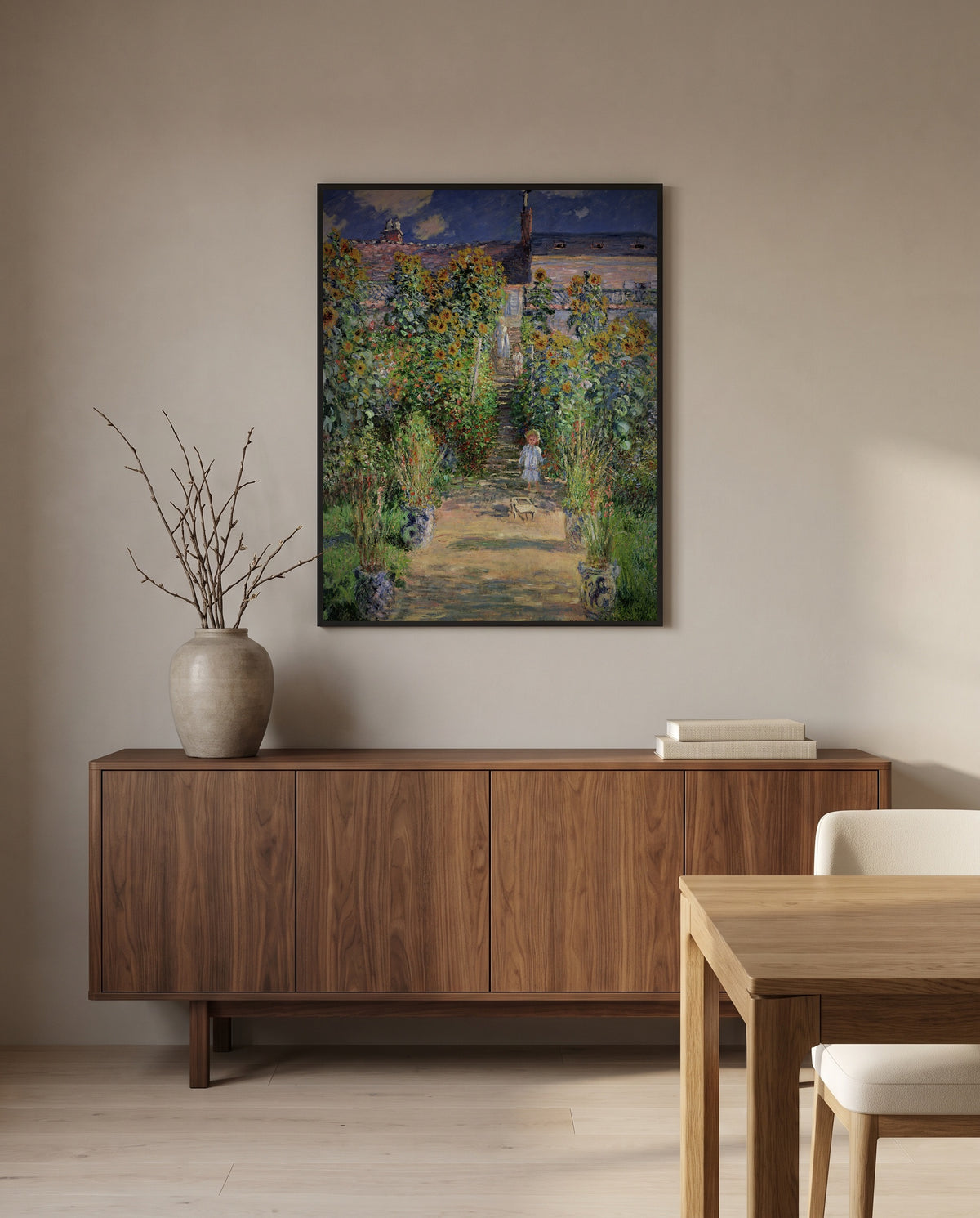 The Artist’s Garden at Vétheuil by Claude Monet in a black frame above a walnut sideboard in a dining room