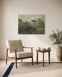 The Artist’s Garden in Argenteuil by Claude Monet as a stretched canvas above a linen lounge chair in a reading corner