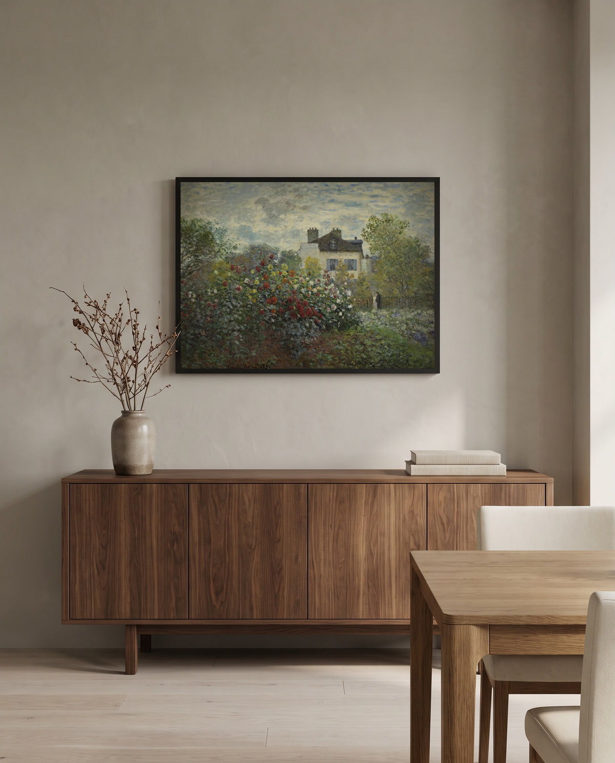 The Artist’s Garden in Argenteuil by Claude Monet in a black frame above a walnut sideboard in a dining room