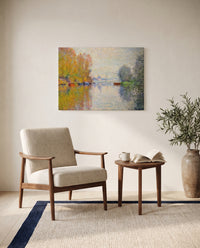 Autumn on the Seine by Claude Monet as a stretched canvas above a linen lounge chair in a reading corner