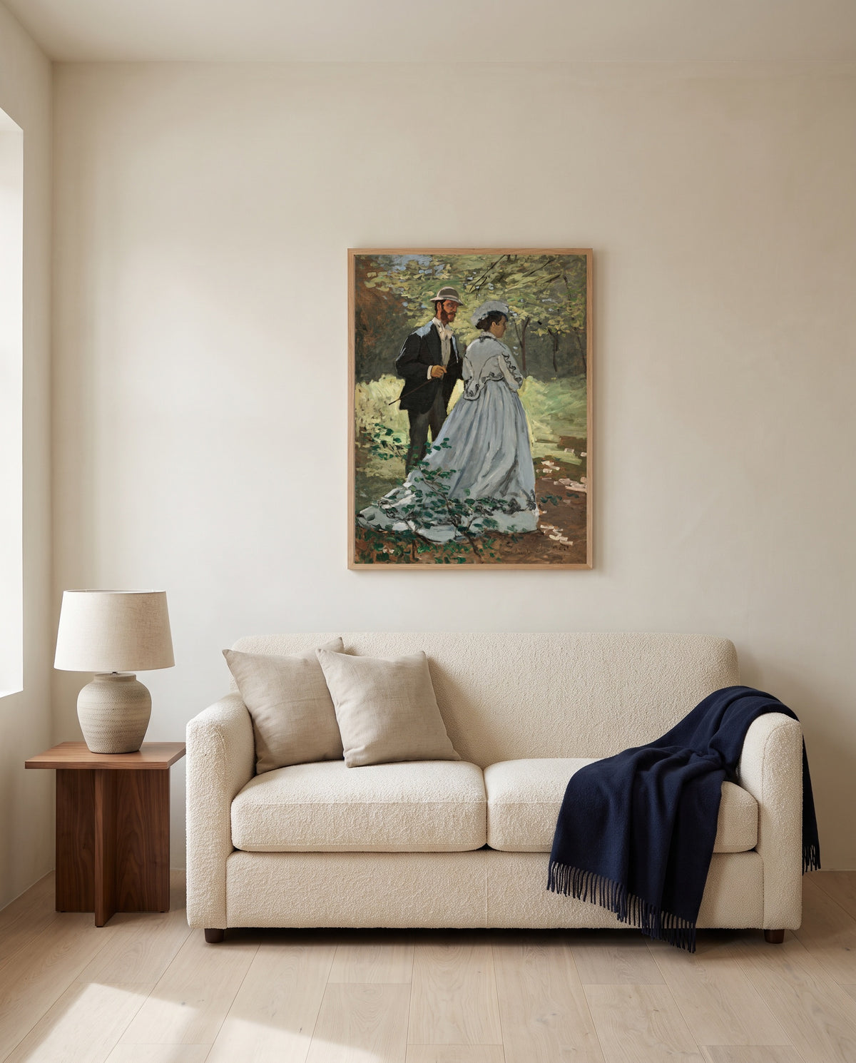 Bazille and Camille by Claude Monet framed in natural oak above a cream sofa in a warm living room