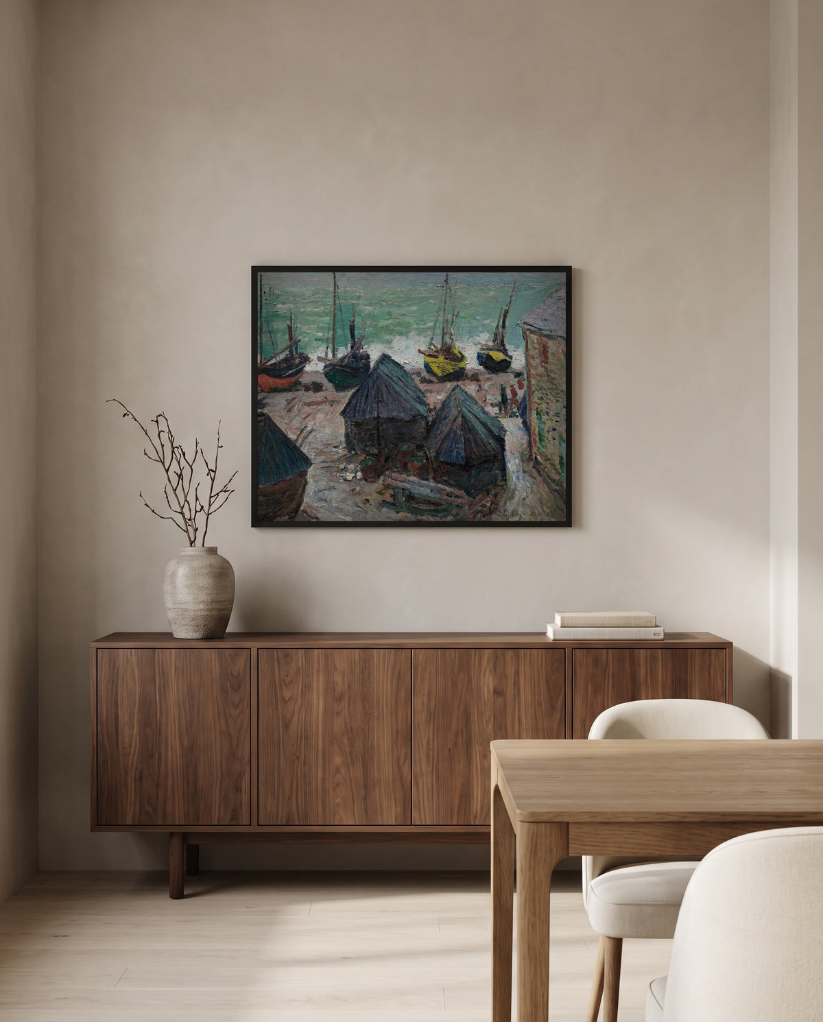Boats on the Beach at Étretat by Claude Monet in a black frame above a walnut sideboard in a dining room