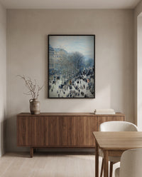 Boulevard des Capucines by Claude Monet in a black frame above a walnut sideboard in a dining room