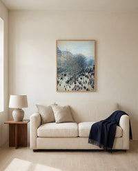 Boulevard des Capucines by Claude Monet framed in natural oak above a cream sofa in a warm living room