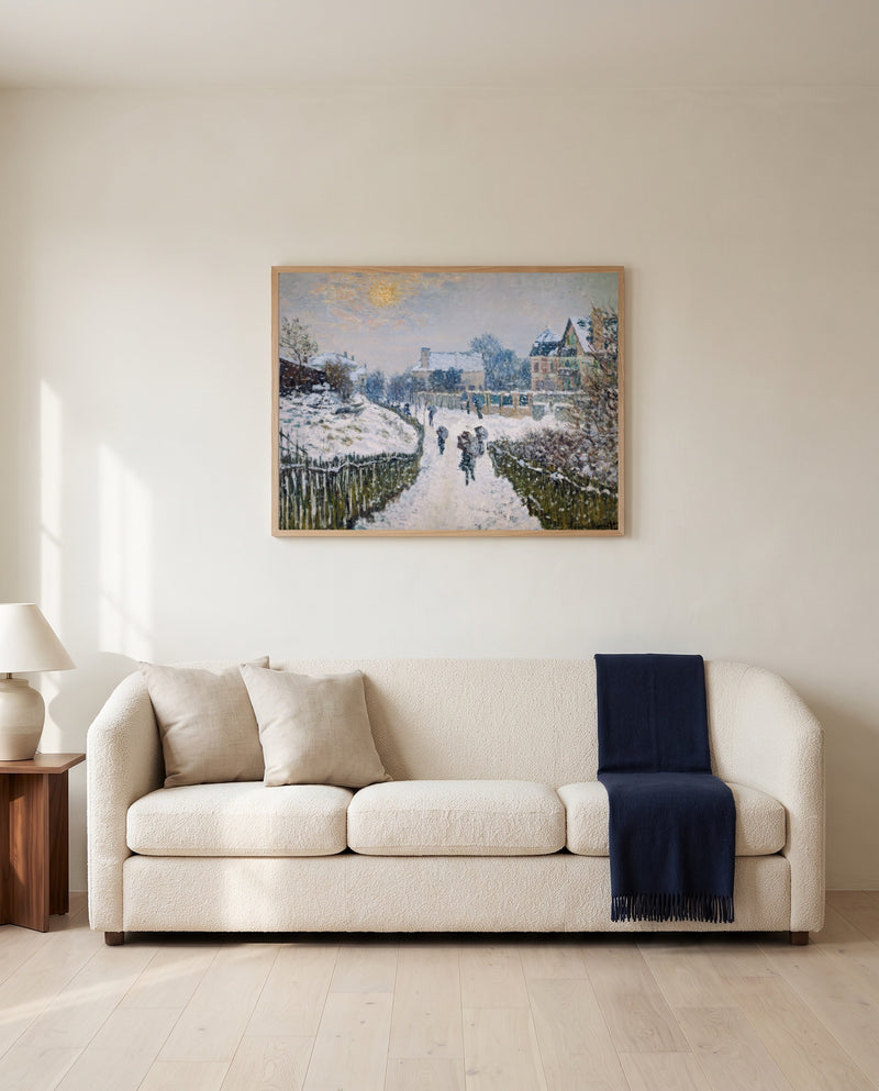 Boulevard Saint-Denis by Claude Monet framed in natural oak above a cream sofa in a warm living room