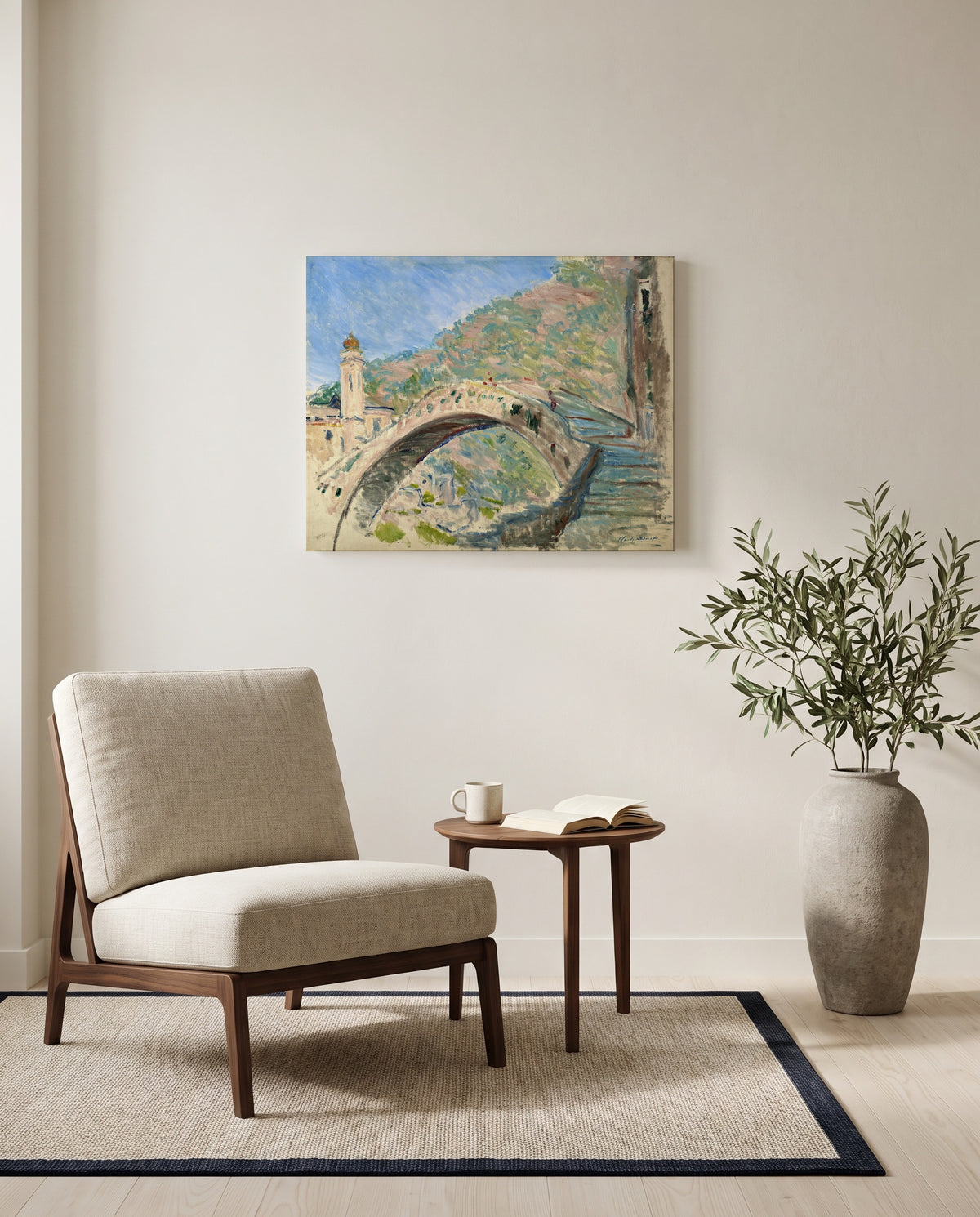 Bridge at Dolceacqua by Claude Monet as a stretched canvas above a linen lounge chair in a reading corner